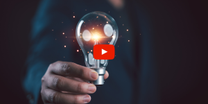 Person holding a lit lightbulb
