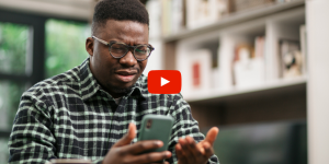 Person looking at their phone frustratingly