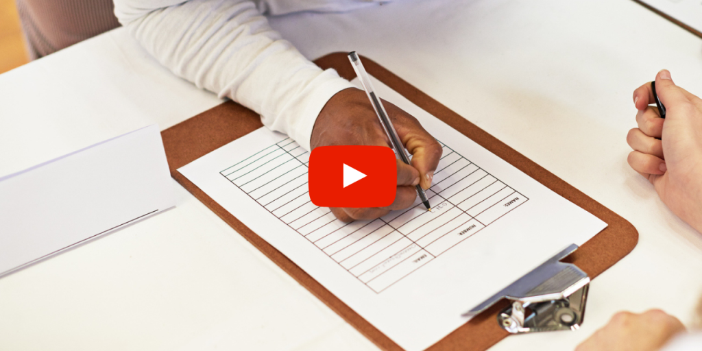 person filling out sign-in sheet