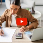Person sitting at a desk working on calculations